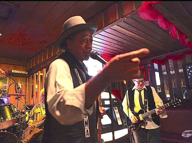 Oklahoma Ollie Live Blues Performance Oklahoma Ollie entertaining a live audience with blues music